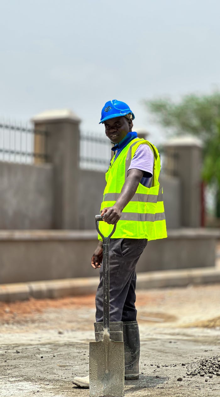 construction-worker-holding-shovel-outdoors-32467383